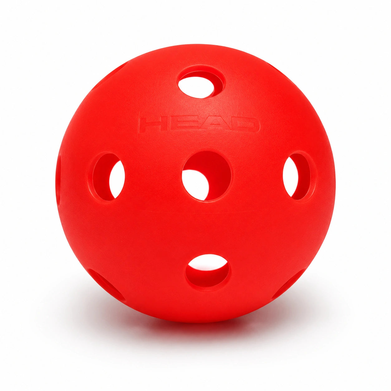 A red HEAD pickleball paddle training ball with multiple circular ventilation holes, shown on a clean white background.